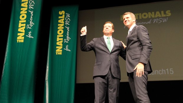 Leader of the NSW Nationals, Troy Grant, is greeted on stage by NSW Premier Mike Baird. 