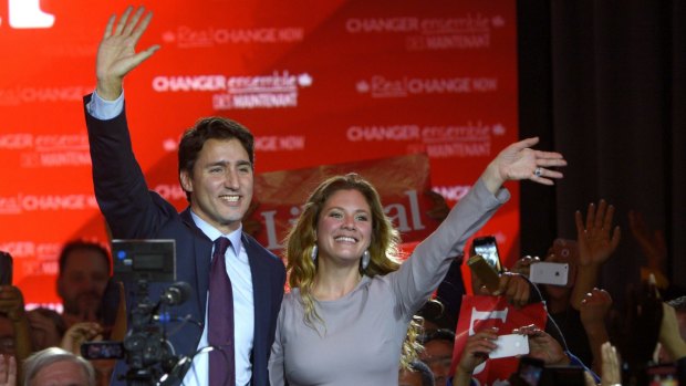 Justin Trudeau waves with his wife Sophie Gregoire in Montreal last year. The couple have now moved onto hand holding.