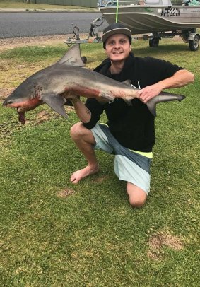 Jamie Leeder with a 1.5m juvenile bull shark.