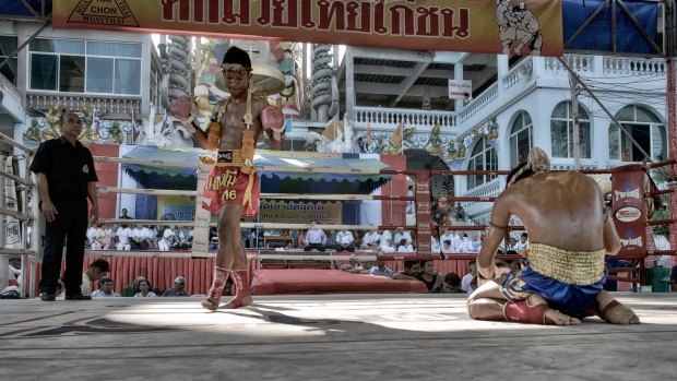 Muay Thai kick boxers performing pre-fight ritual of respect, guidance and safe keeping.