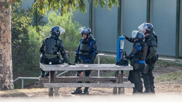 Heavily armoured riot police on the grounds of the Melbourne Youth Justice Centre.