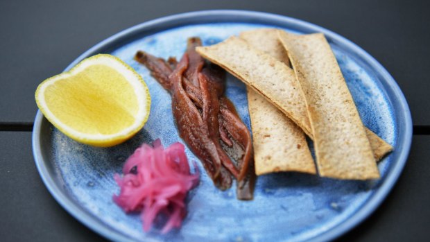 Ortiz anchovies are carefully arranged with house-pickled onions, a lemon cheek and crostini.