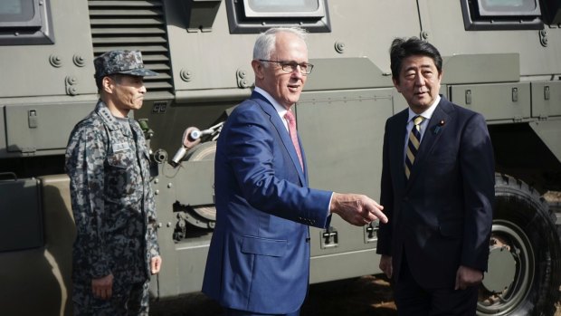 Malcolm Turnbull and his Japanese counterpart Shinzo Abe, right, in front of a Bushmaster armoured vehicle in Japan last week.