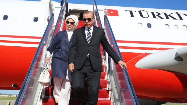 Turkey's President Recep Tayyip Erdogan and his wife Emine disembark from a plane after arriving in Washington.