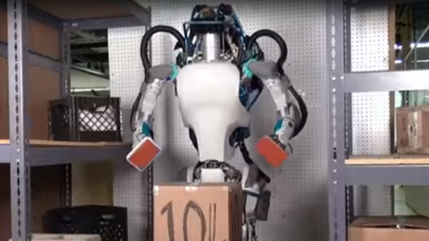 An Atlas picks up a box in the Boston Dynamics video.