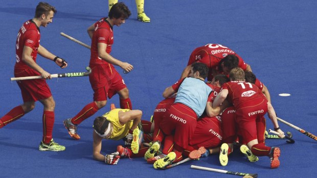 Belgium players celebrate their equaliser against Australia in hockey's Champions Trophy.