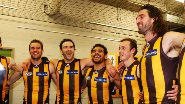 Winners are grinners: Hawks sing the club song after trouncing Sydney on Saturday.