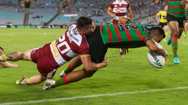 Too late: Richie Kennar beats the tackle of Morgan Escare of the Warriors to score at ANZ Stadium.