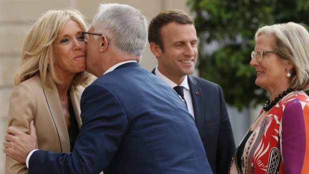 Malcolm Turnbull kisses Brigitte Macron, wife of French President Emmanuel Macron on arrival at the Palace.