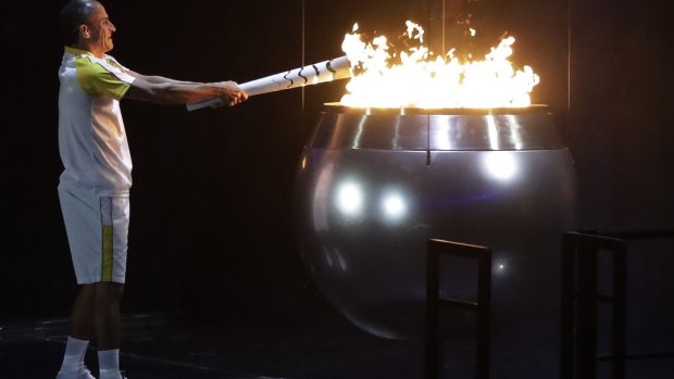 Vanderlei de Lima lights the Olympic flame.