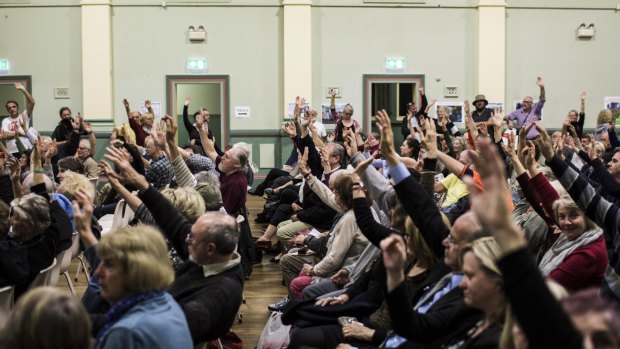 Attendants at a Stop WestConnex meeting at the Balmain Town Hall demonstrate the local opposition to the project. 