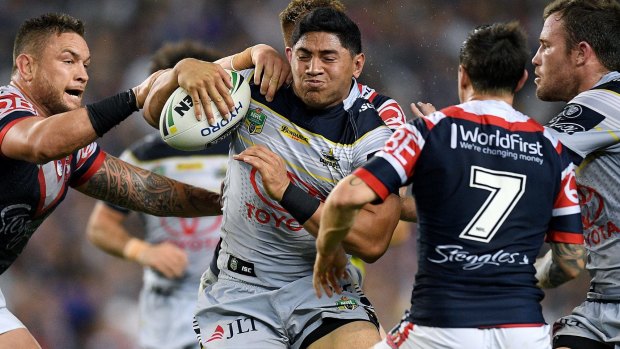 Raging bull: Jason Taumalolo leaves a trail of devastation in his wake against the Roosters.
