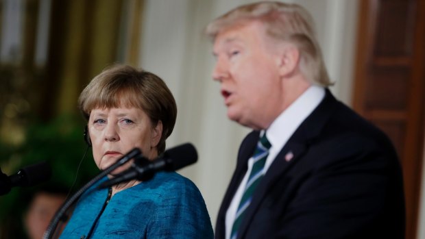 German Chancellor Angela Merkel listens as President Donald Trump speaks during their joint news conference.