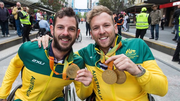 Heath Davidson (left) and Dylan Alcott  during a parade in Melbourne on Wednesday to celebrate the Australian Paralympic team.