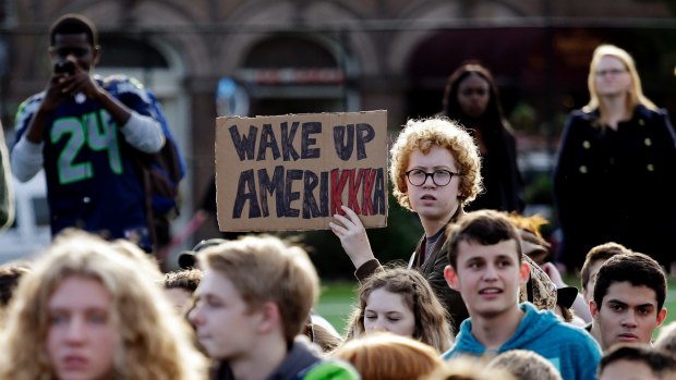 Students walk out from classes to protest the election of Donald Trump as president in Seattle on Monday.