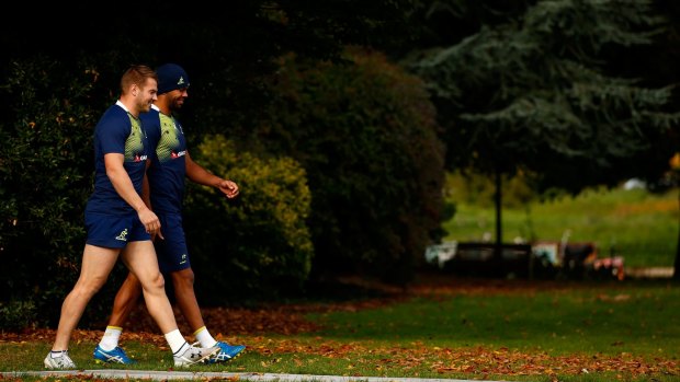 Taking a stroll: Drew Mitchell and Kurtley Beale make their way to the pitch during a training session at The Lensbury Hotel in London.