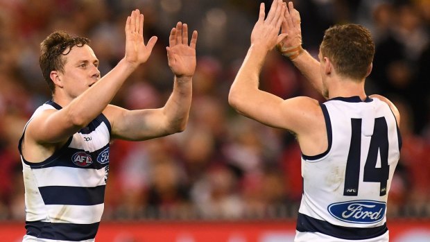 High fives: Mitch Duncan and Joel Selwood enjoy another score on a dominant night.