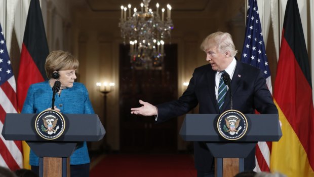 Donald Trump and Angela Merkel have met for the first time in an awkward encounter that could not disguise the gulf that separates them.