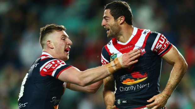 Son of a gun: Jackson Hastings (left) celebrates with Roosters legend Anthony Minichiello during this year's final series.