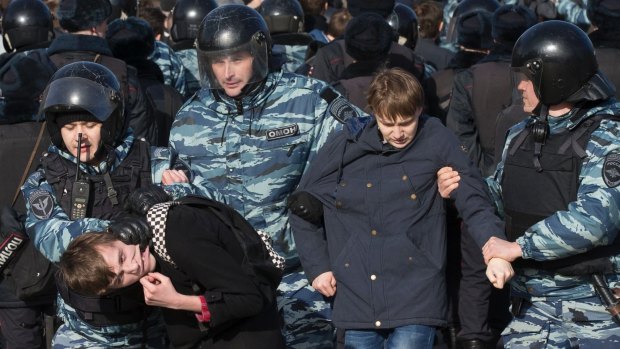 Police detain protesters during a rally in Moscow.