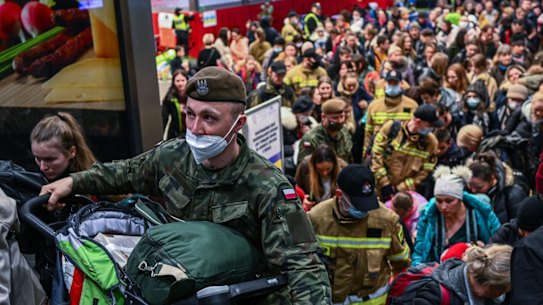 KRAKOW, POLAND - MARCH 15: People who fled the war in Ukraine walk towards a humanitarian train to relocate refugees to Berlin on March 15, 2022 in Krakow, Poland. More than half of the roughly 3 million Ukrainians fleeing war have crossed into neighbouring Poland since Russia began a large-scale armed invasion of Ukraine on February 24, 2022. (Photo by Omar Marques/Getty Images)