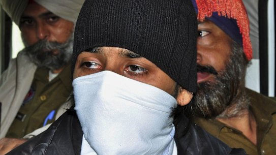 Puneet Puneet, foreground, is escorted by policemen at a district court in Rajpura, in northern India.