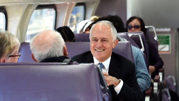 Prime Minister, Malcolm Turnbull, pictured here on a train in Sydney's west, has announced a "City Deal" for the region.