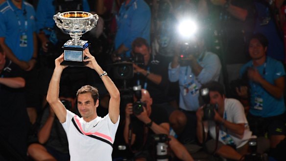 Roger Federer holds the trophy aloft inside the Rod Laver Arena.