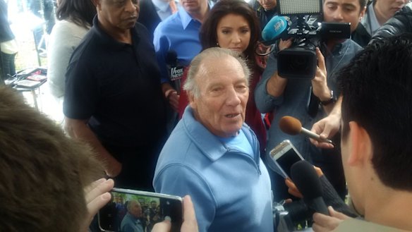 Frenzy ... Landlord Doyle Miller stands in the middle of a media scrum after opening up his apartment to reporters.
