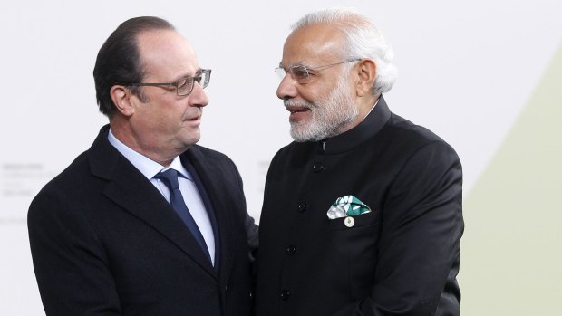French President Francois Hollande shakes hands with Indian Prime Minister Narendra Modi as he arrives at the climate conference in Paris.