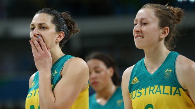 Canberra Capitals player Marianna Tolo (left) and Natalie Burton leave the court dejected after their quarter-final exit at the Olympics.