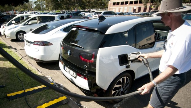 Electric car owner Gary Crighton fills up at UQ St Lucia's electric vehicle charging station.