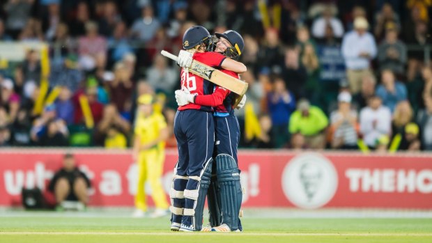 England's Katherine Brunt embraces Danielle Wyatt after Wyatt scored a century in the third T20 match at Manuka oval on Tuesday. Photo: Sitthixay Ditthavong