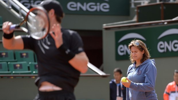 Team Murray: Amelie Mauresmo checks a ball as Andy Murray practises.