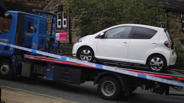 A car is removed for forensic testing near to where Jo Cox, Labour MP for Batley and Spen, was shot and stabbed outside Birstall Library.