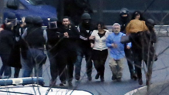 Members of the French police special forces evacuate the hostages after launching the assault at a kosher grocery store.