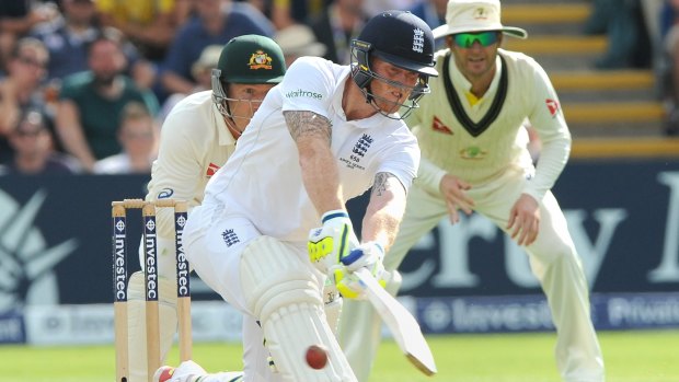 England's Ben Stokes plays a sweep shot during day three of the first Ashes Test cricket match, in Cardiff, Wales.