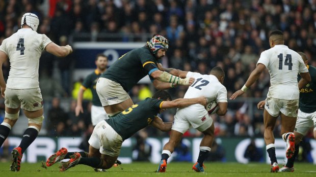 Reeled in: Victor Matfield and Jan Serfonein fell Kyle Eastmond during England's loss to South Africa at the weekend.