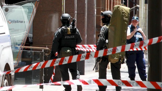 Police snipers enter Martin Place from Macquarie Street as the siege unfolded.