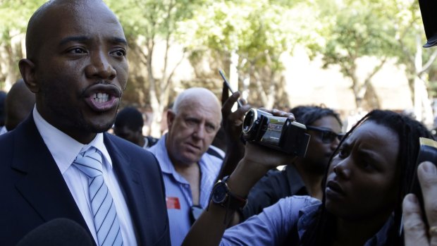 Musi Maimane, leader of the official opposition Democratic Alliance party, addresses journalist outside the Constitutional Court in Johannesburg on Thursday.