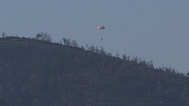 A pilot parachutes out of the warplane which went down in Syria's north-western Turkmen town of Bayirbucak.