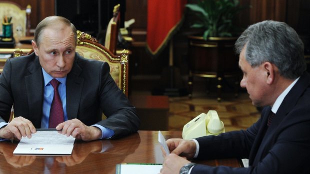 Russian President Vladimir Putin, left, listens to Russian Defence Minister Sergei Shoigu at a meeting in the Kremlin on Monday.