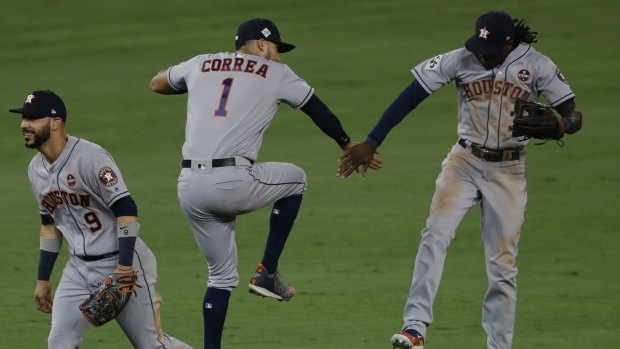 Houston Astros' Carlos Correa, Cameron Maybin and Marwin Gonzalez celebrate after game two.
