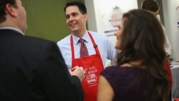 Wisconsin Governor Scott Walker greets guests at the Republican Party of Iowa's Lincoln Dinner in Des Moines, Iowa. 