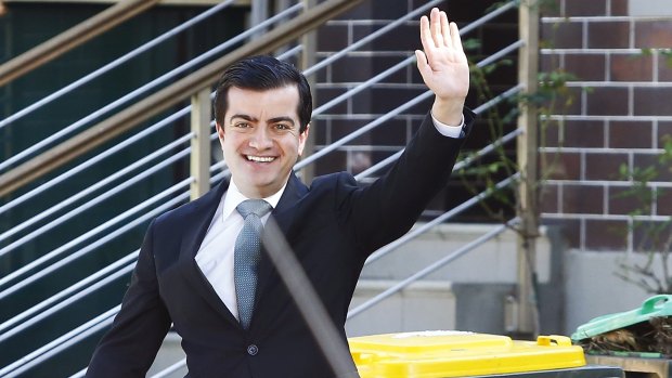 Labor Senator Sam Dastyari is all smiles as he leaves to conduct his press conference.