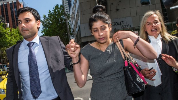 Deepak Dhankar leaves the Melbourne County Court with his wife and lawyer. 