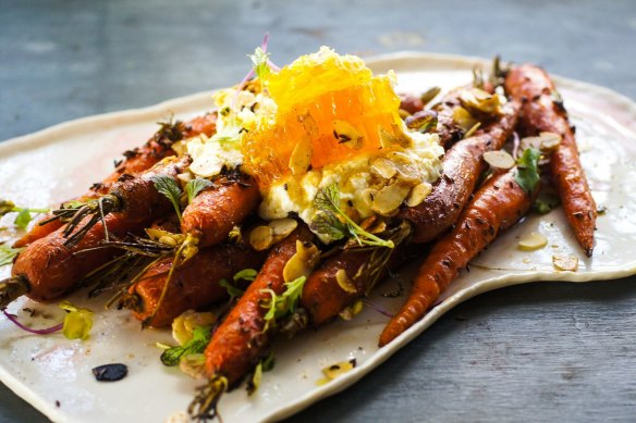 Roasted carrots with a hunk of fresh honeycomb.