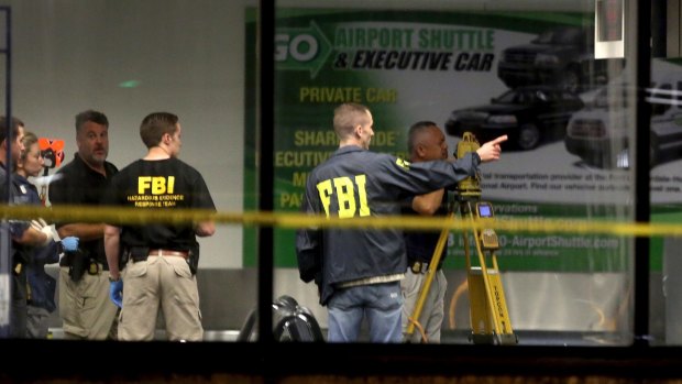 Investigators work in Terminal 2 at Fort Lauderdale-Hollywood International Airport.