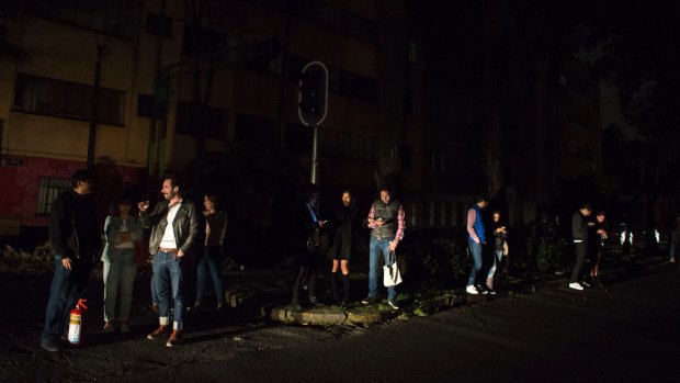 Residents of La Roma in Mexico City check their phones in the dark after a magnitude 8.1 earthquake caused a blackout.