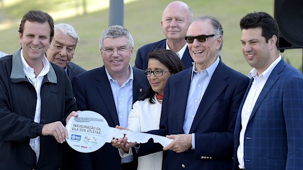 From left, Rio's Mayor Eduardo Paes passes the key to the Olympic Village to Organising Committee President Carlos Arthur Nuzman, last week.